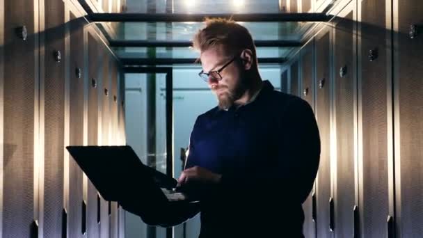 Data Center worker controleert Server computers, typen op een laptop. Beveiligingsspecialist computer systeem. — Stockvideo