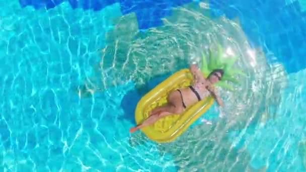 Женщина в бикини расслабляется на надувном матрасе в бассейне . — стоковое видео