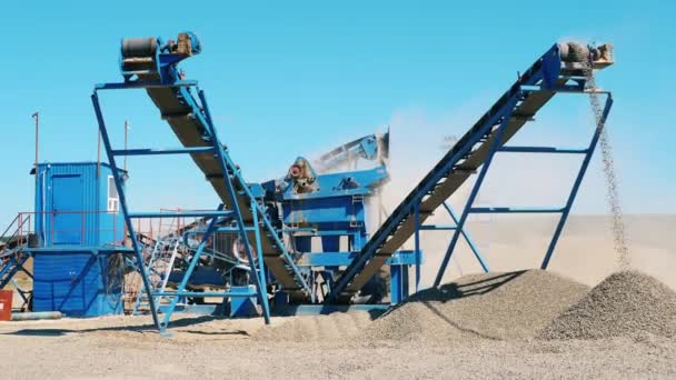 Grinding vehicles are cracking gravel. Aerial view of mining quarry. — Stock Video