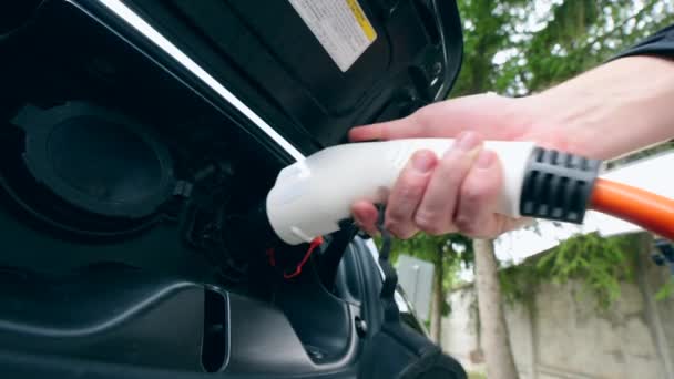 A person launches recharging process of an electrocar — Stock Video