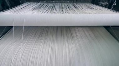 Tekstil fabrikası ekipmanları. Dizeleri beyaz konuları bol dikiş tezgahı
