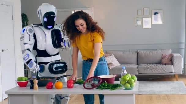 A lady and a robot are cooking and trying food — Stock Video