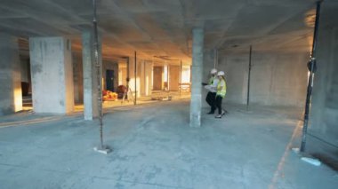 Mühendisler bir inşaat binasında bir binada yürür.