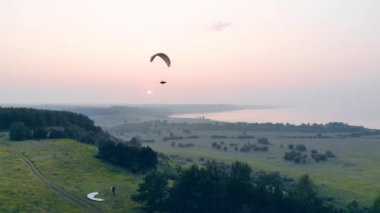 Parawing bir kişi yeşil manzara üzerinde süzülen