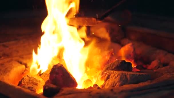 Poker is being used to shuffle burning coals — Stock Video