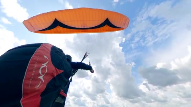 Профессиональный спортсмен летает с глайдером над зеленым полем . — стоковое видео