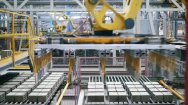 Modern kol bir fabrikada bir konveyör tuğla alır.