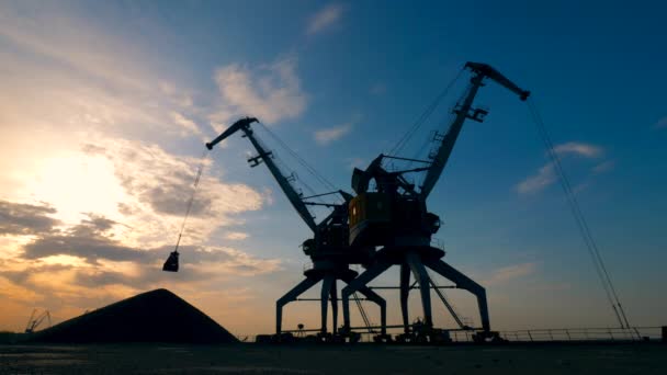 Massive industrial cranes are relocating rubble at sundown — Stock Video