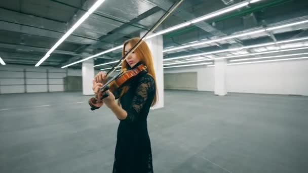 Prostorná prázdná hala se ženou hrající na housle — Stock video