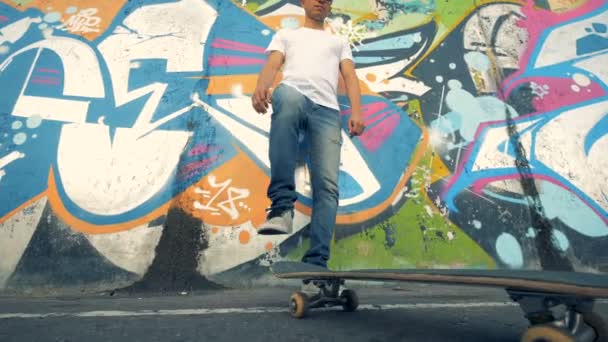 Young skater doing tricks, bottom view. — Stock Video