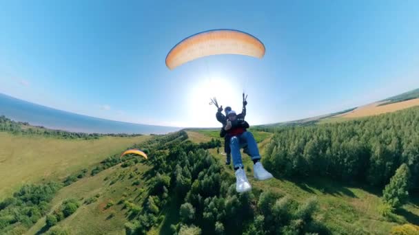 Esportes pessoas voando com parapente sobre campos . — Vídeo de Stock