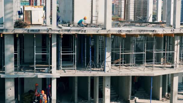 Construtores trabalham em um canteiro de obras . — Vídeo de Stock