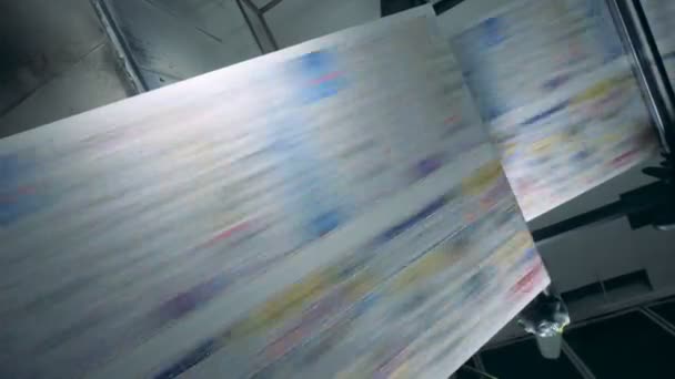 Fake news concept. Uncut printed paper rolling through the factory machine — Stock Video