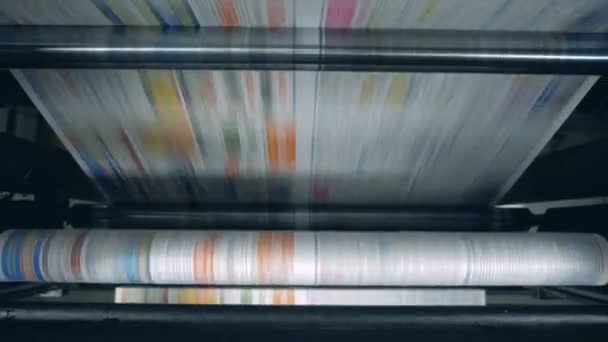 Rolling machine is relocating coloured printed paper — Stock Video