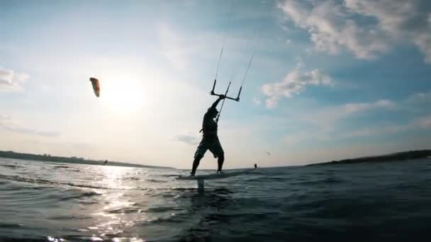 Um homem montando na prancha de surf na água . — Vídeo de Stock