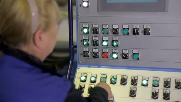 Female worker operating industrial control panel, display at a modern industrial equipment. — Stock video