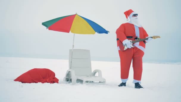 Snowy landscape with Santa Claus playing guitar — Stock Video