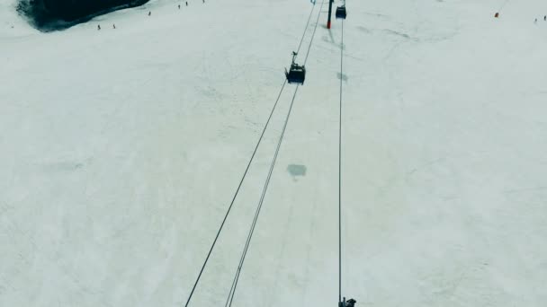 Ropeway con funiculares en movimiento en una vista superior. Ascensor de esquí camino por cable en las montañas . — Vídeos de Stock