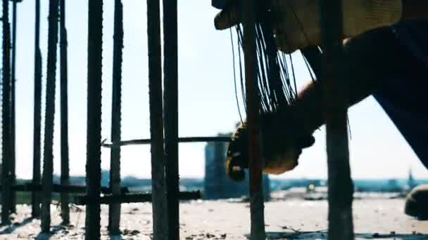 Wires are getting tied around the metal stems by the worker — Stock Video