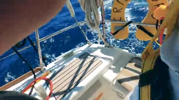 One man steers yacht wheel while sailing. — Stock Video