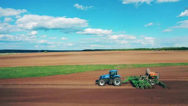 Farming tractor is sowing the land of a massive field — Stock Video