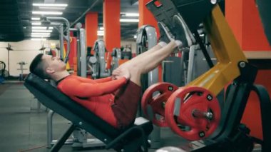 Sporcu bacaklarını güçlendirmek için egzersiz yapıyor.