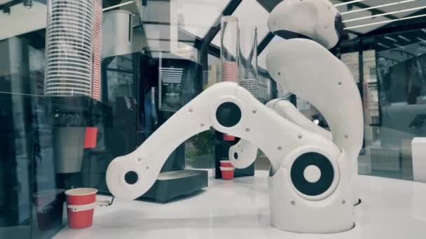 Robot is using arms to relocate cups of coffee — Stock Video