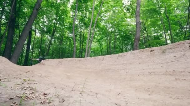 Bmx гонщик перетинає стежку в лісі — стокове відео