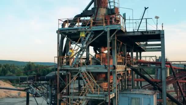 Ingenieurs lopen naar boven een metalen constructie in de haven — Stockvideo