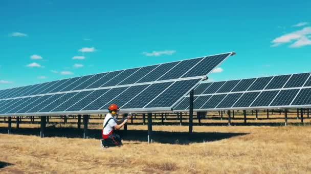 Especialista masculino está reparando painéis solares no campo Economia de energia, eficiência energética, conceito de energia renovável. — Vídeo de Stock