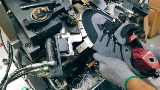 Factory worker using a shoe making machine at a footwear facility. Close up — Stock Video