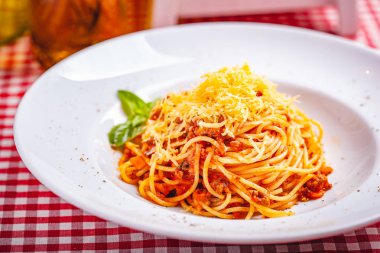 İtalyan mutfağı. Spagetti bolognese et, parmesan peyniri ve domates beyaz tabakta. Yakın çekim