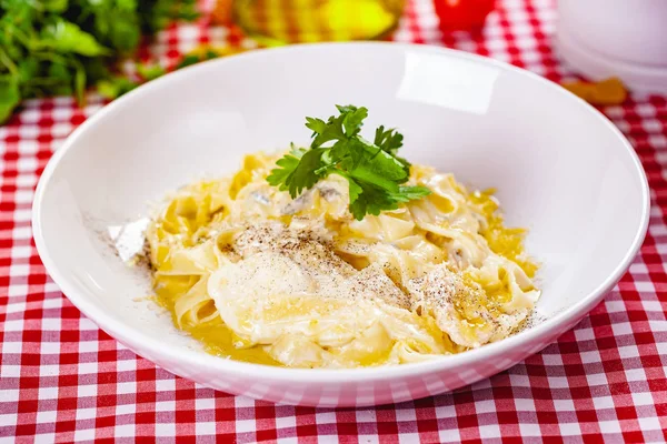 Italian Pasta with cheese on white plate. Close up