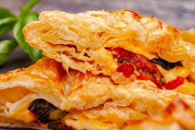 Puf böreği kiraz domates, mozzarella peyniri ve fesleğen ahşap rustik masa üzerinde. Yakın çekim