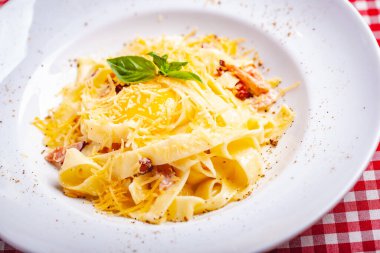 İtalyan mutfağı. Pastırmalı makarna, peynir ve yumurta. Kapat.