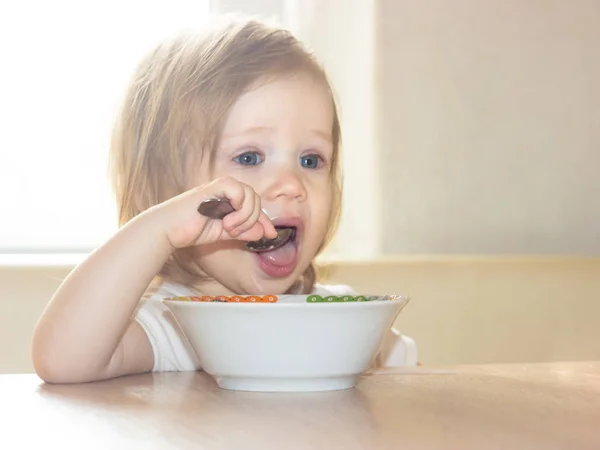 Little Shaggy Baby Girl Pleasure Alone Holds Spoon Eats Delicious — Stock Photo, Image