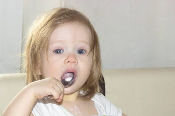 Little Shaggy Baby Girl Pleasure Alone Holds Spoon Eats Delicious Royalty Free Stock Images