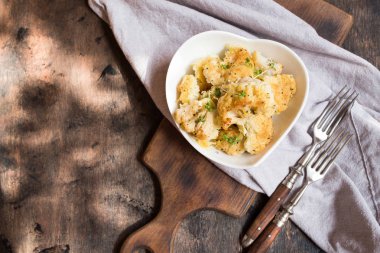 Cauliflower casserole with cheese in a cream sauce. Cauliflower gratin with bechamel sauce/