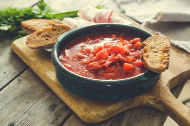 Ukrainian and russian national red soup borsch. Beetroot soup on wooden background/