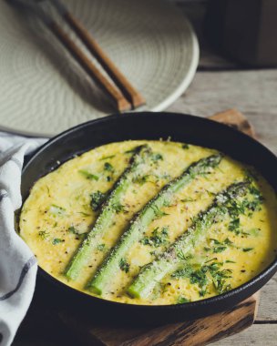 Çırpılmış yumurtalı kuşkonmaz. Kızartma tavasında kuşkonmaz ile omlet..