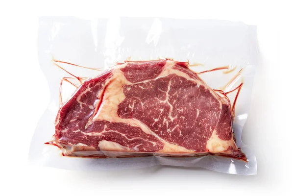 Beaf steak vacuum sealed ready for sous vide cooking isolated on white background, top view