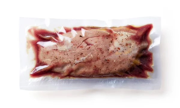 Duck breast vacuum sealed ready for sous vide cooking isolated on white background, top view