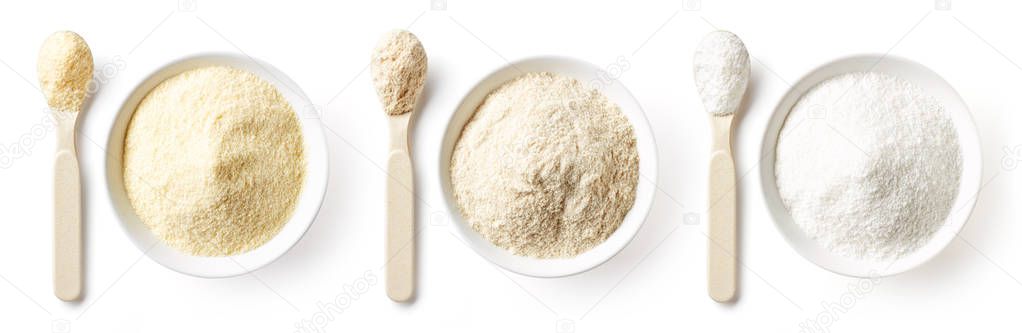Three bowls of porridge powder for babies isolated on white background, top view