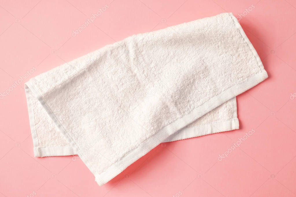 White spa towel on pink,from above