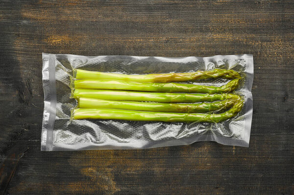 Спаржа вакуум запечатанный готовы к sous vide приготовления пищи на деревянной та
