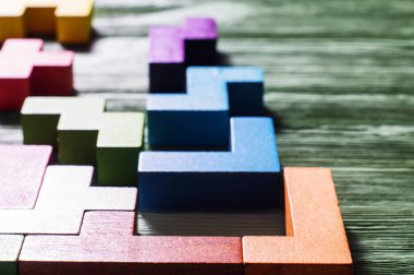 Bulanık Tetris, yakın çekim. Mantıksal düşünme kavramı. Ahşap arka plan üzerinde geometrik şekiller.