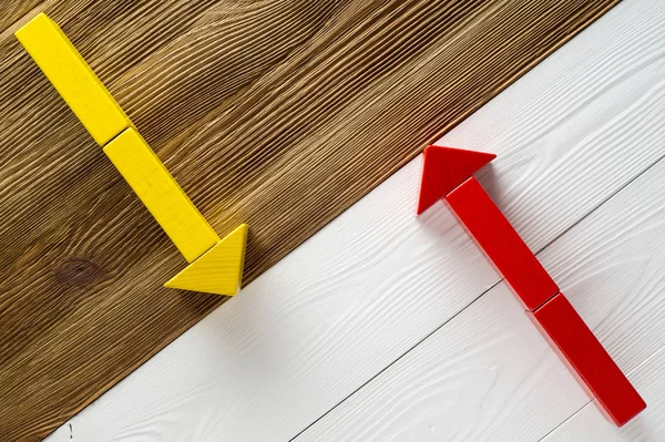 Two arrows pointing in opposite directions. Two wooden arrows red and yellow.