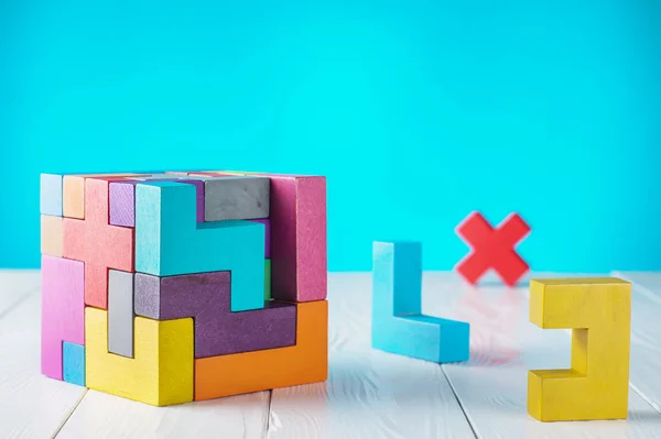 Concept of decision making process. Concept of creative, logical thinking. Different geometric shapes wooden blocks on white wooden background, copy space. Geometric shapes in different colors.