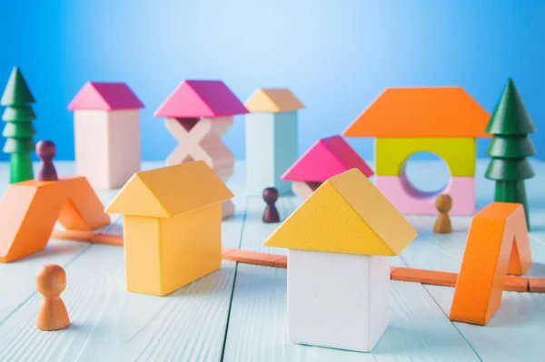 玩具木房子从彩色块在蓝色背景 施工理念 房地产 建造一个房子从一个木制立方体 在办公桌上 — 图库照片