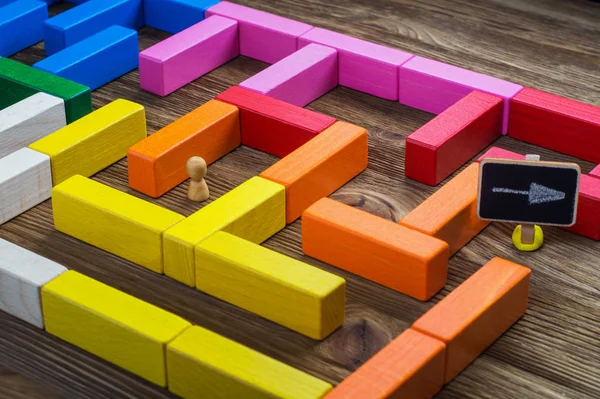 Man in the labyrinth, the search for the exit. Labyrinth of colorful wooden blocks. The man in the maze. The concept of a business strategy, analytics, search for solutions, the search output.